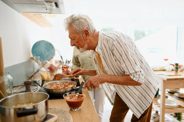istock Senior man cooking with his beautiful wife 1707907498