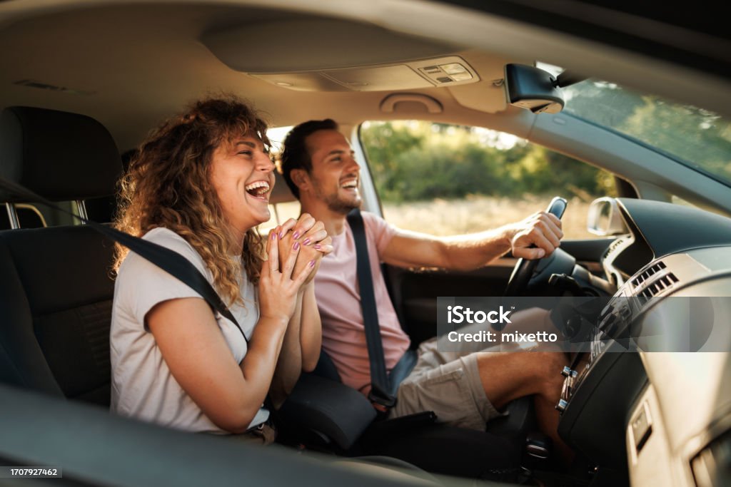 Road Trip Romance Young couple shares lighthearted moments and laughter during their adventurous car journey Car Stock Photo