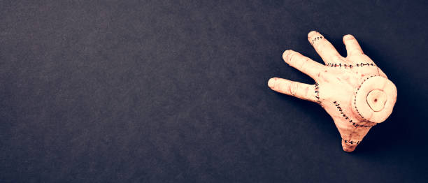 istock Halloween banner with severed hand the Thing from Wednesday series 1707939942