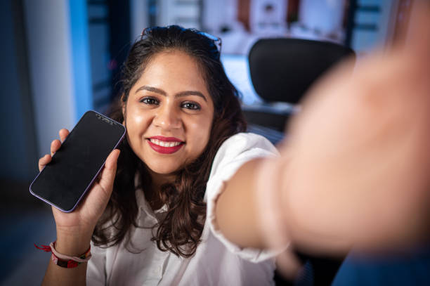 istock Smiling woman taking selfie by camera 1707949777