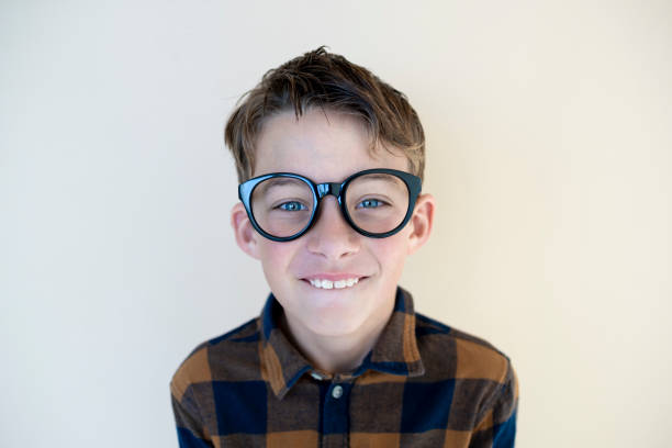 Portrait of young nerd on blackboard.