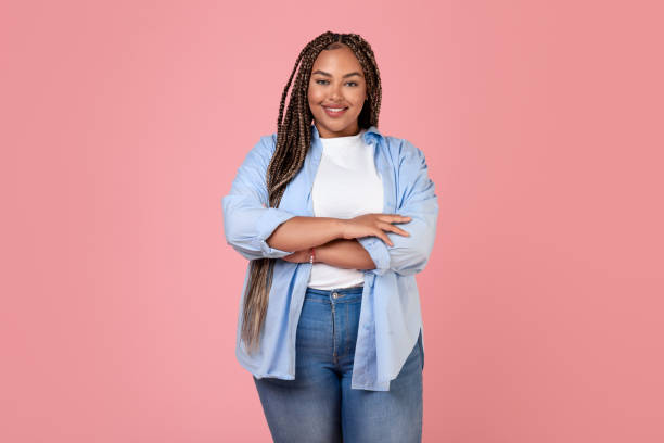 istock Smiling Overweight Lady Standing In Studio On Pink Background 1707974004