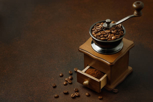 istock coffee grinder with roasted beans on the brown table 1707976585