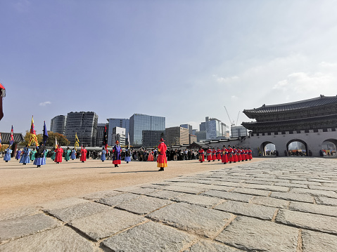 Seoul, South Korea - October 27, 2022: Korean ancient old soldier warriors guard changing event among many tourists in Gyeongbokgung Palace front ground.