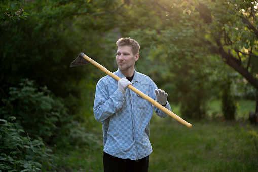 plantation agrarian worker holding a hoe, close up portrait