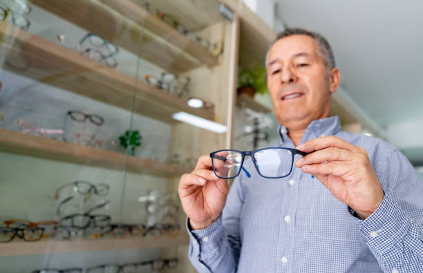 istock Happy man trying on glasses at the optometrist 1708008437