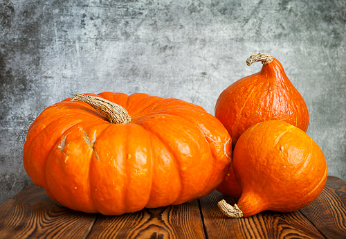 Pumpkins on wooden table, rustic background, copy space