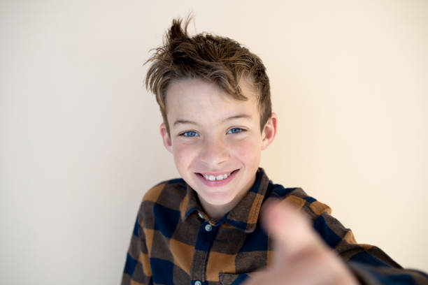 portrait of cool, young boy in front of brown background