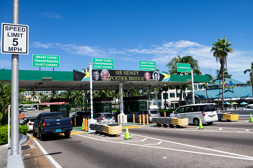 Nassau, Bahamas - September 21, 2023: Cars stop at the toll booth on the Sir Sidney Poitier Bridge connecting Nassau and Paradise Island.