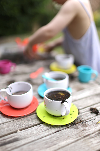 Children's play tea set full of mud coffee in a domestic garden