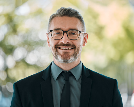 Mature man, business and portrait outdoor with glasses for professional career and positive attitude. Face of happy entrepreneur or CEO person with pride, confidence and smile for corporate growth