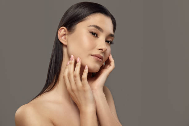 istock Girl touching her face with hands enjoying soft smooth skin. 1708049594