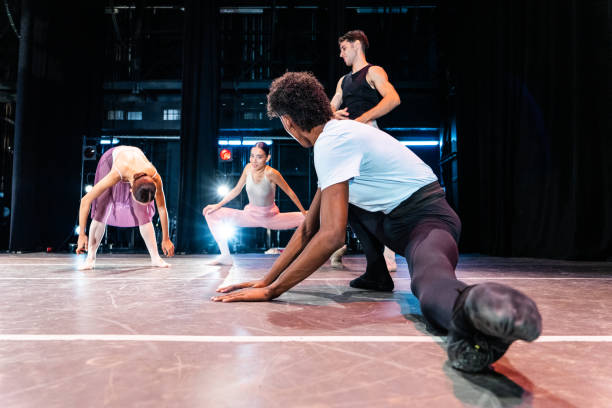 istock Young ballet dancers stretching at theater 1708087099