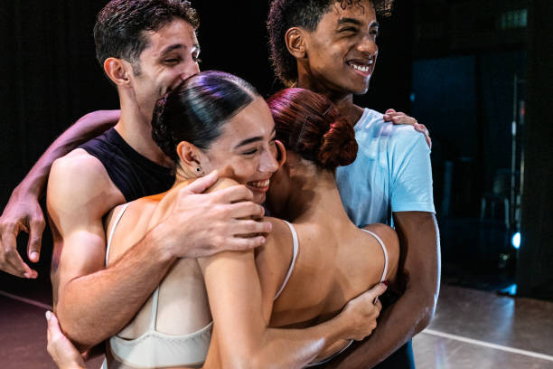 Ballet dancers celebrating after the performance at stage theater