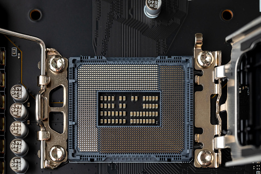 CPU pins on the motherboard. Open socket on a modern motherboard close-up. Multi-core and multi-threading. View from above
