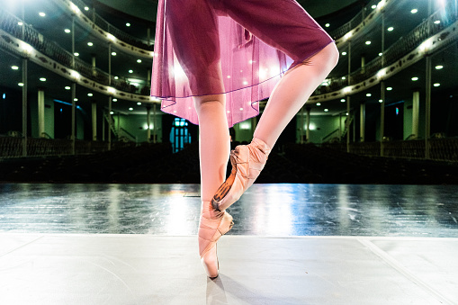 Low section of ballerina on tiptoe on the stage theater