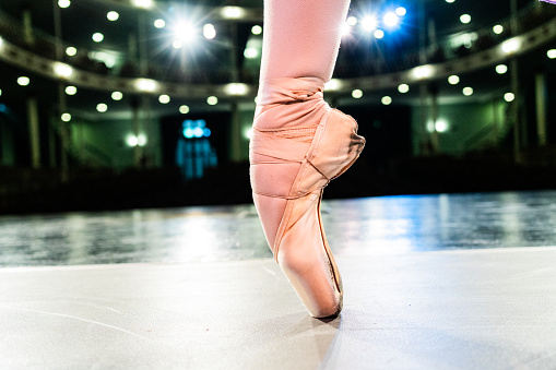 Close-up of a ballerina on tiptoe on the stage theater