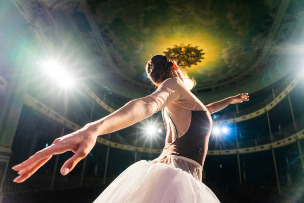 Young ballerina performing on a stage theater