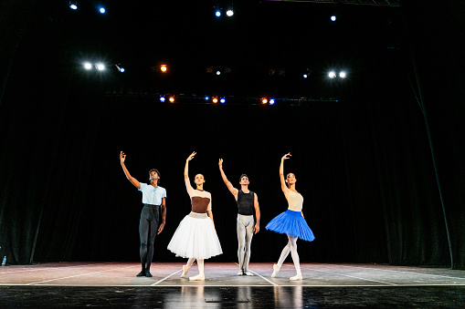 Young ballet dancers performing on a stage theater