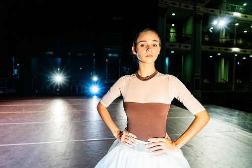 portrait of a young ballerina in a black tutu, view from the back