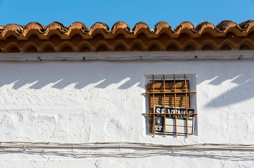 On sale sign in Spanish on an old window, in the traditional centre of Spain, in Castile La Mancha.