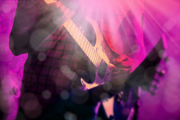 istock Playing electric guitar in purple light 1708122460