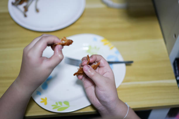 hand holding food and snack while eating on table