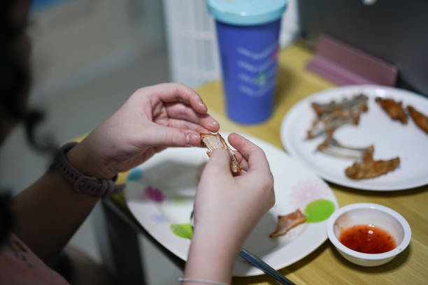 hand holding food and snack while eating on table