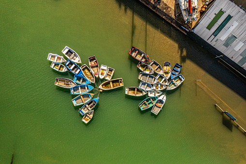 Aerial photo from a drone of a collection of moored rowing boats in Tollesbury, Essex, UK. Captured in September 2023.