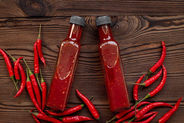 istock Red chili sauce ketchup or tabasco with ripe hot pepper 1708154502