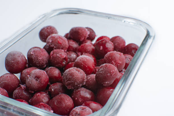 Extreme closeup of frozen mulberries and cherries.