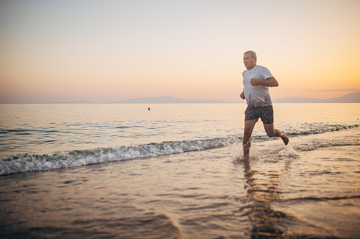Fitness training, a man exercises along the sea coast
