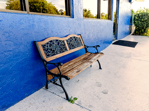 Wooden bench at storefront in Florida