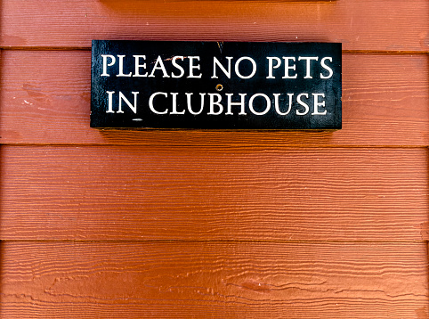Close up no pets sign on  building wall in Florida