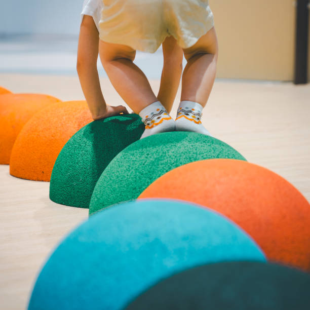 Little boy climbing rock rubber in playground, indoor.