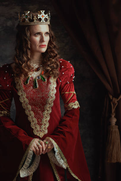 istock medieval queen in red dress with crown 1708261656