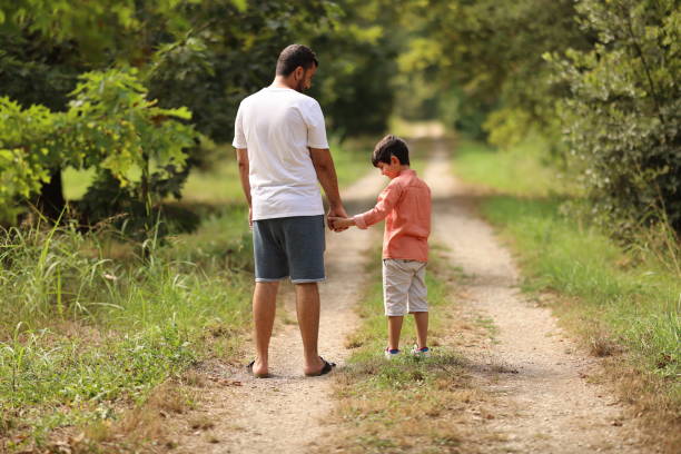 istock Father walking with is son at the park 1708272221