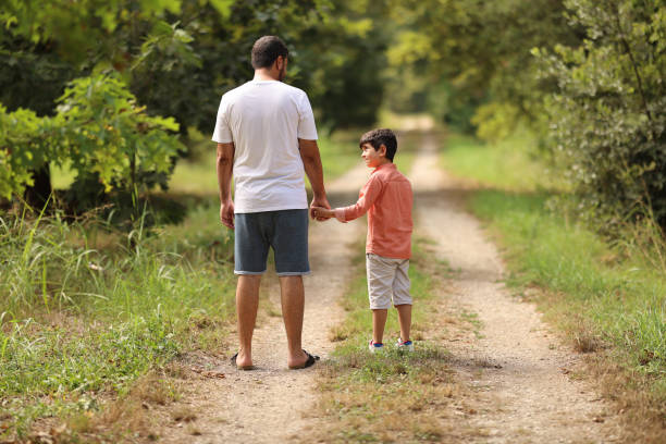 istock Father walking with is son at the park 1708272782