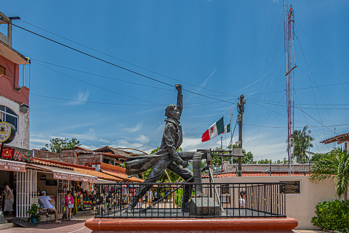 People dine on restaurant patios in the historic Coyoacan neighborhood of Mexico City, Mexico in the evening.