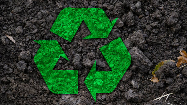 Recycle symbol in the soil. stock photo