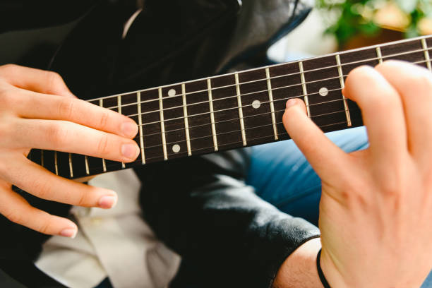 istock Placing the fingers on a guitar to play some notes by a professional guitarist. 1708286152