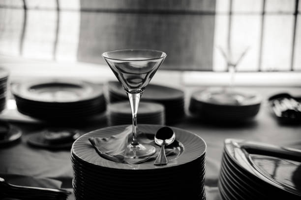 Empty ice cream cup elegantly arranged on plates, black and white photo.