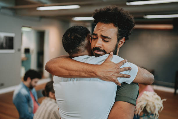 People hugging each other in emotional support group