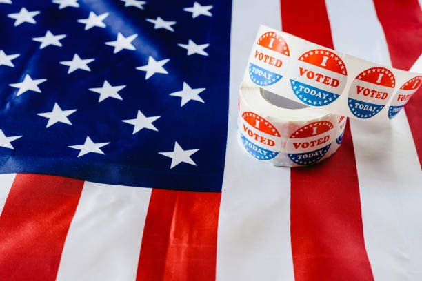 istock I vote today stickers roll, in US elections on American flag. 1708318862