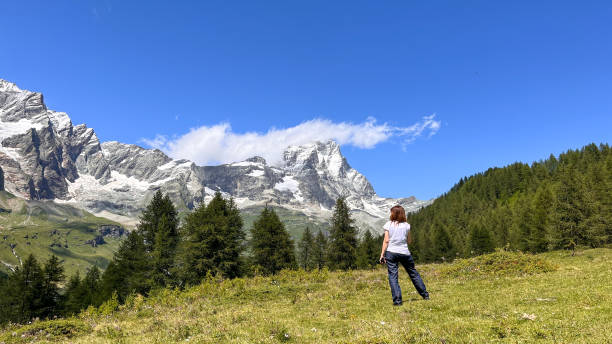 istock Cheerful woman looking at Matterhorn peak 1708324366