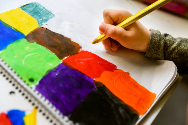 istock Child painting pictures in bright colors while developing his creativity. 1708324368