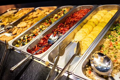 Trays with food for self-service buffet in a restaurant.