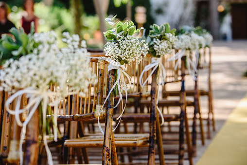 istock Floral arrangements for empty chairs for a wedding ceremony in spring 1708339189