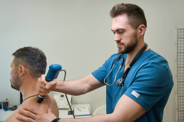 istock Experienced physiotherapist performing ESWT procedure on adult man 1708341406