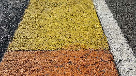 Asphalt background with white and yellow lines.